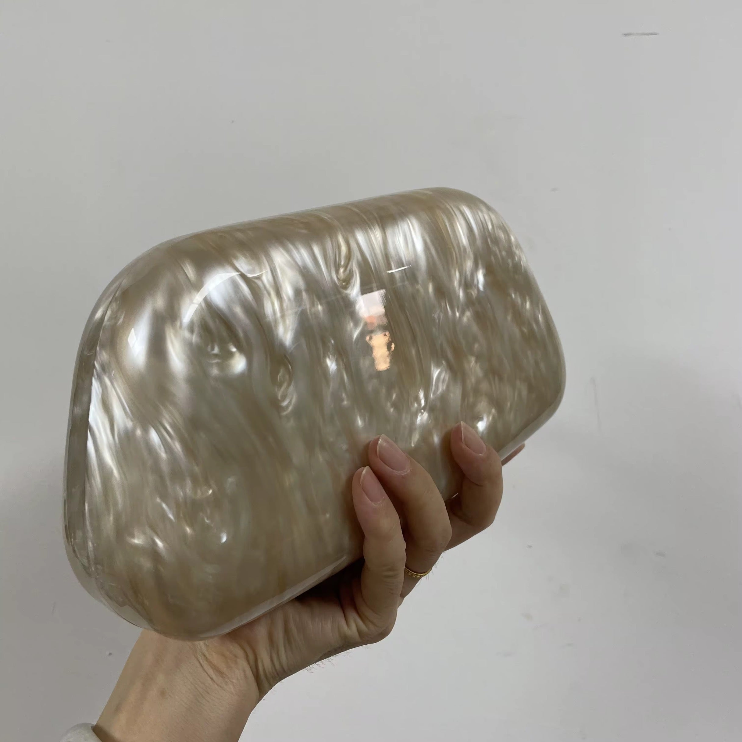 Pearlescent Acrylic Clutch with Sculptural Gold Wave Handle
