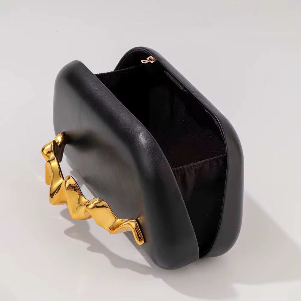 Avant-Garde Black Clutch with Sculptural Gold Hand Grip